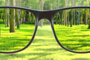 Seeing clearly looking through a pair of glasses while everything outside of it is blurry